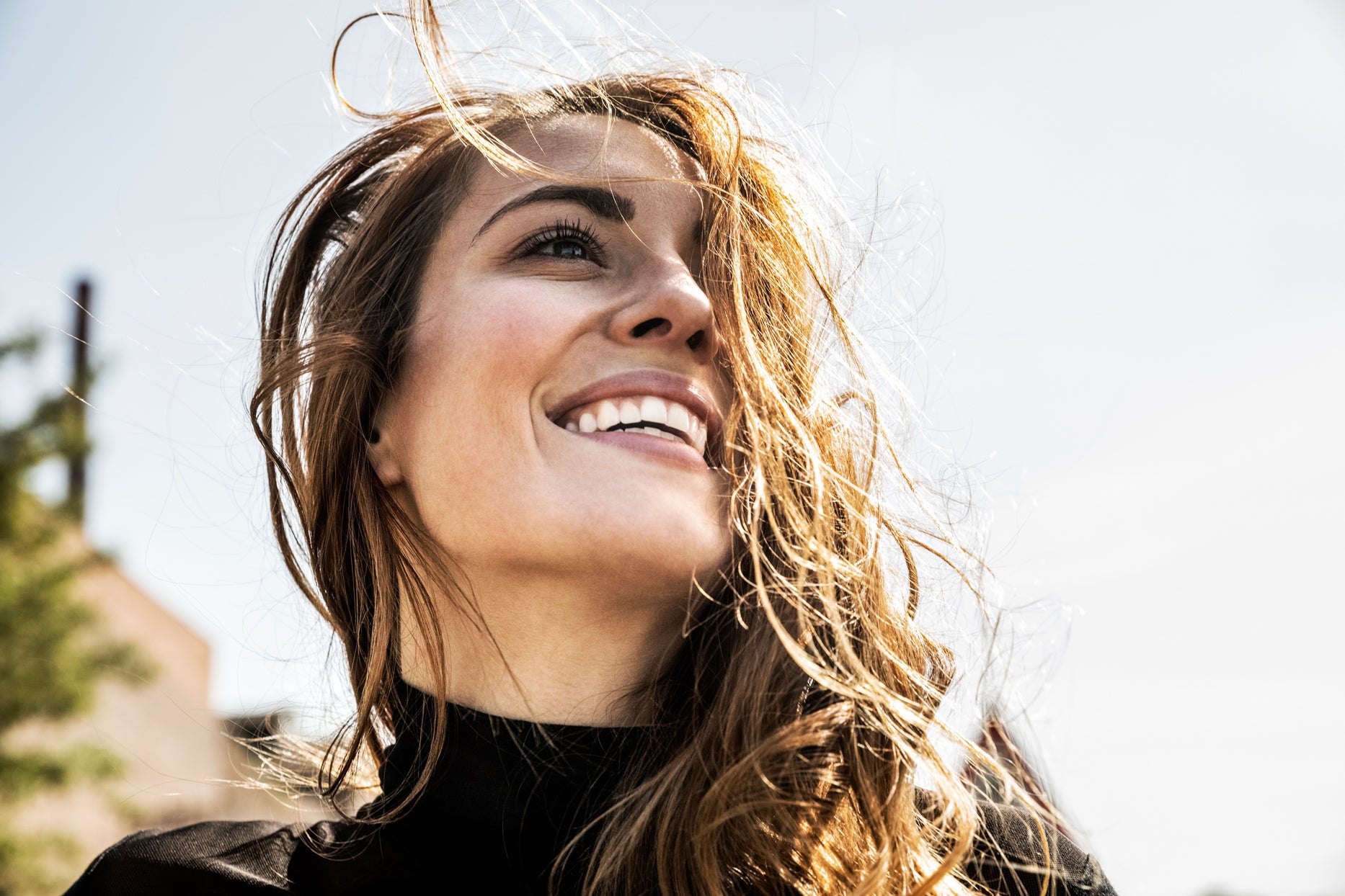 ADVERTISEMENT Save Pin  More woman smiling while hair blows in wind  CREDIT: WESTEND61 / GETTY IMAGES