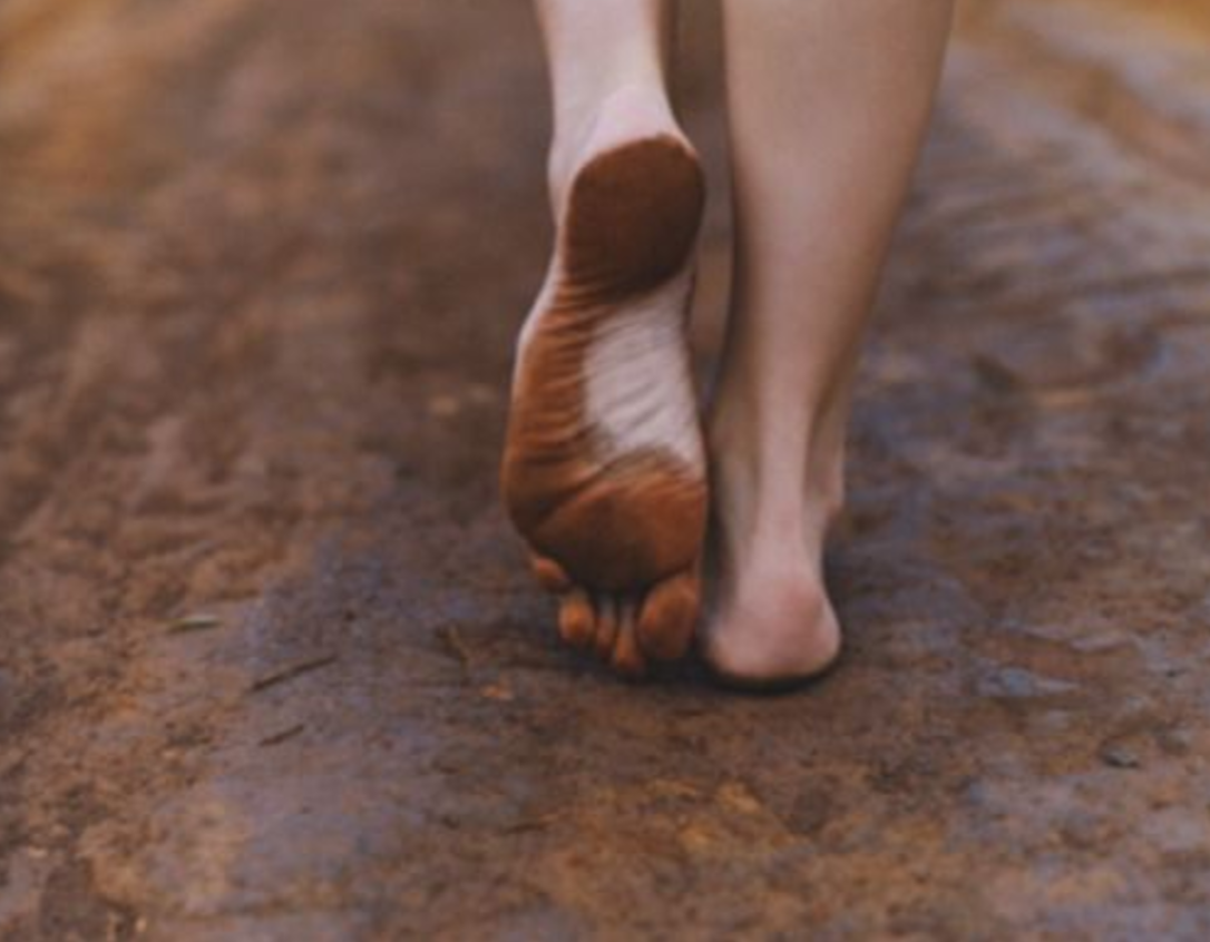 bare feet walking on clay road