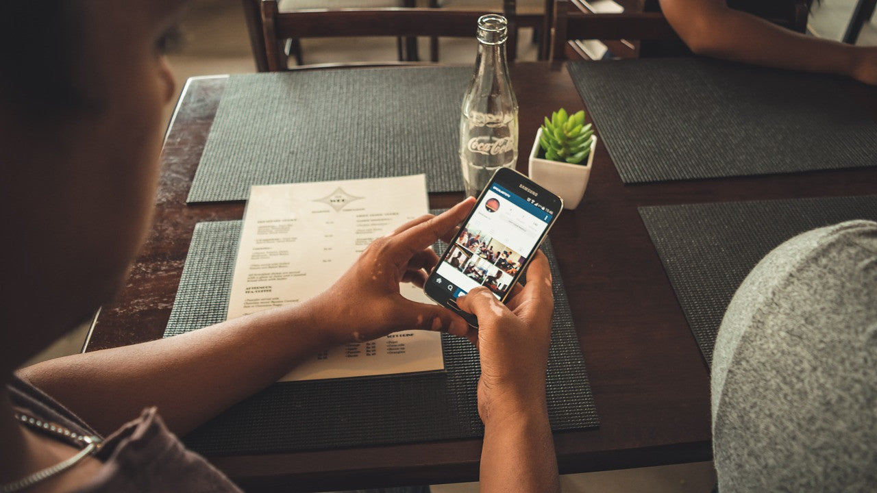 person looking down at phone