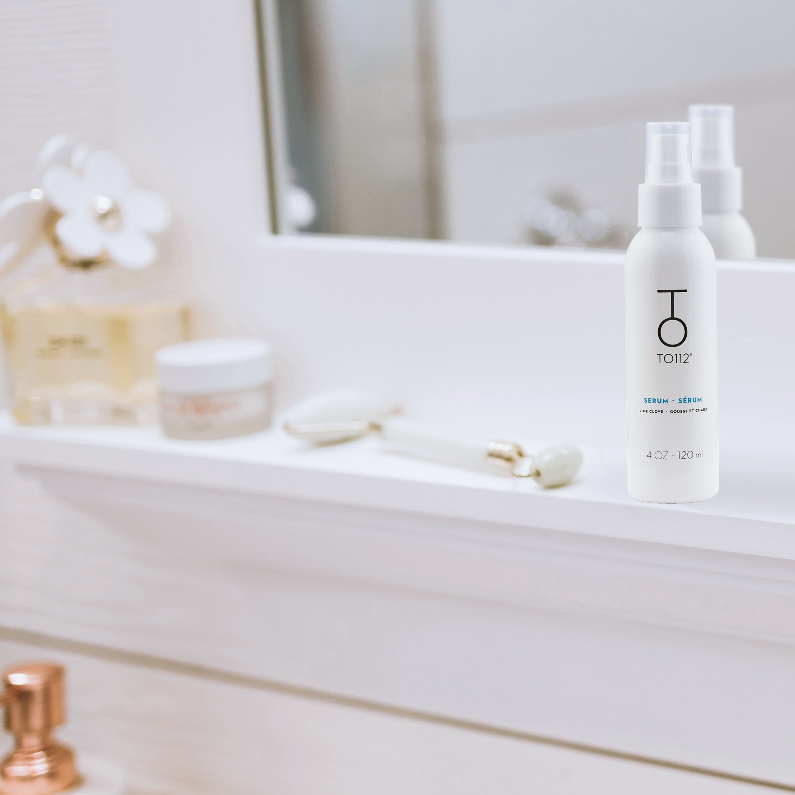 TO112 hair serum sitting on white bathroom counter top