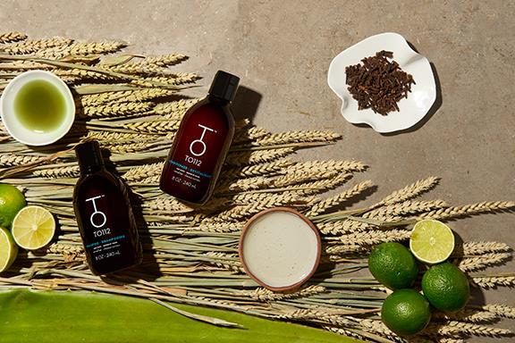 8oz bottle of To112 shampoo and conditioner for normal hair with limes and cloves place around product bottles
