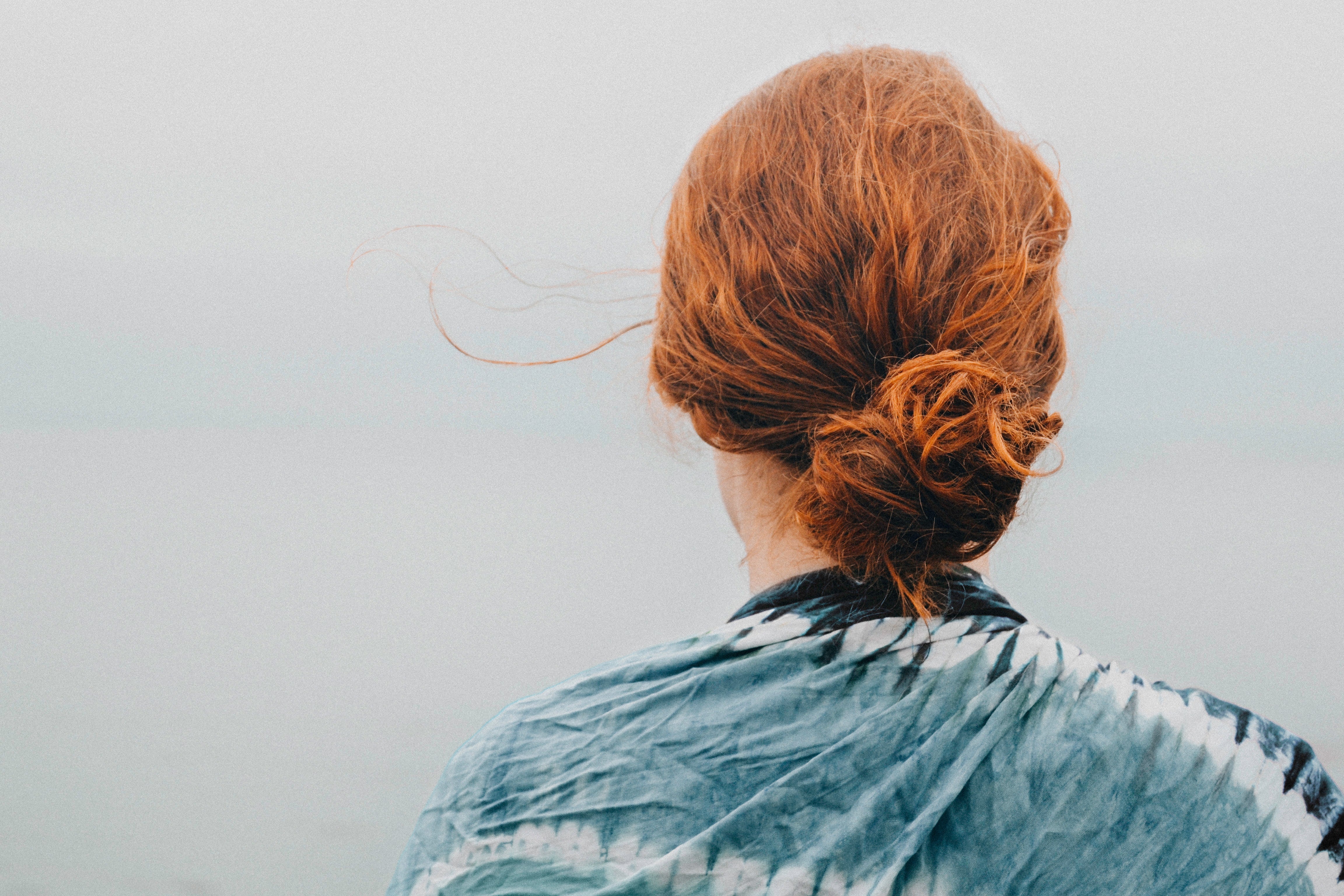 Back of woman's head with frizzy red hair 